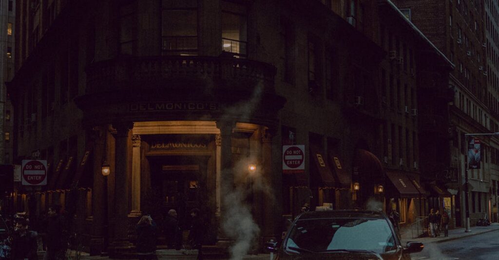 Dramatic night cityscape featuring a car on a dimly lit street corner with an illuminated historic building.